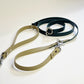Powder Tan and Dark Green Biothane Multifunctional Dog Leash with Silver Carabiners, thoughtfully arranged for display.